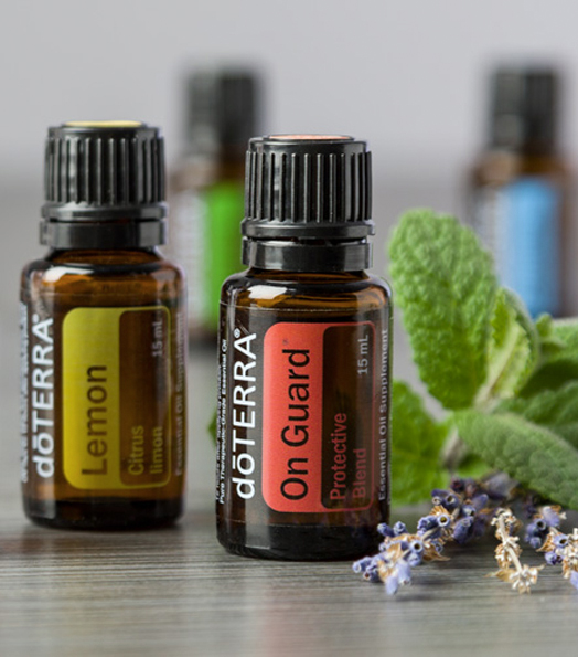 doTERRA image of 2 essential oils bottles and mint, dried flowers